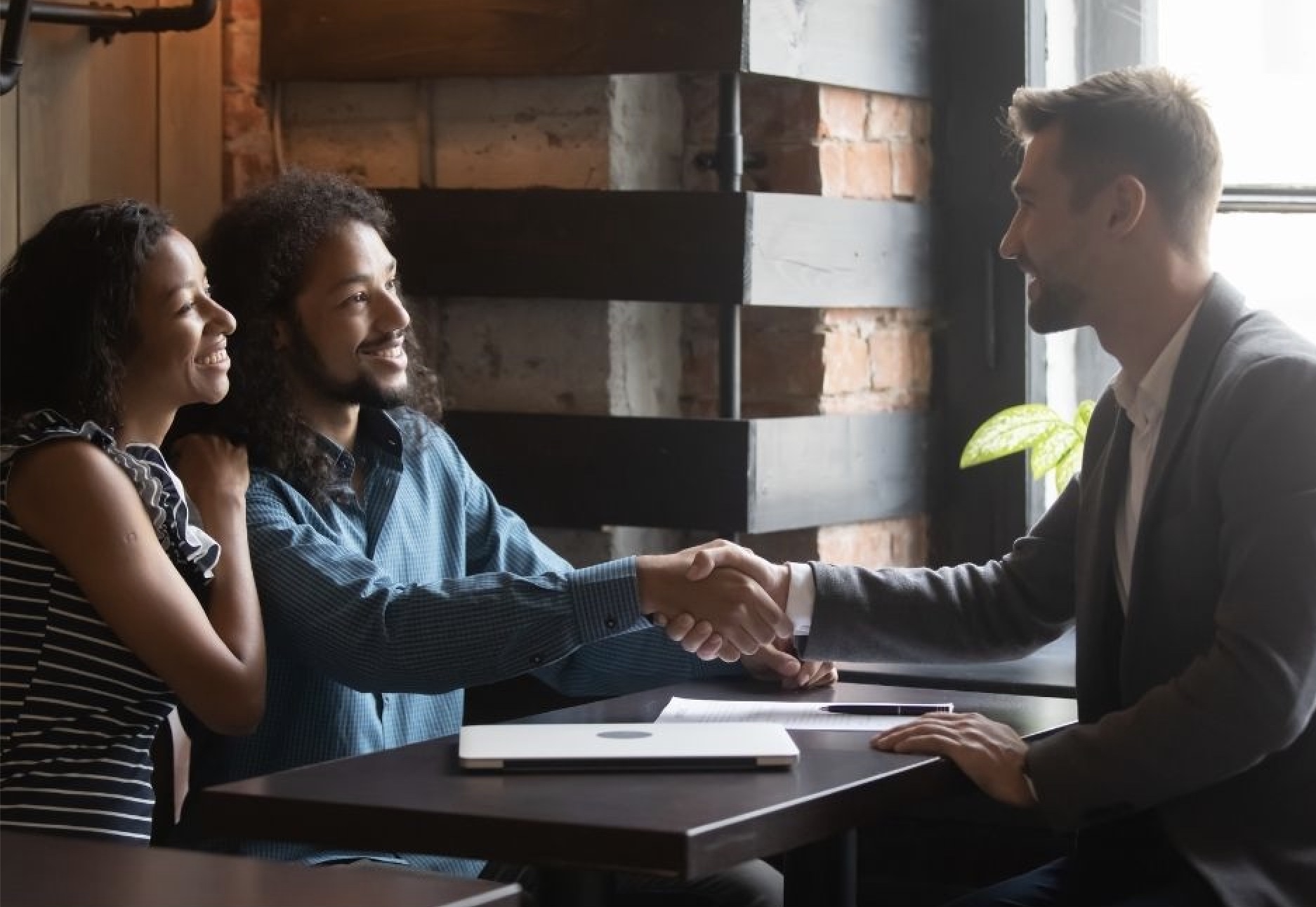 Agent and client shaking hands after closing a deal