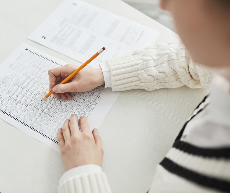 Real estate school student taking notes in class